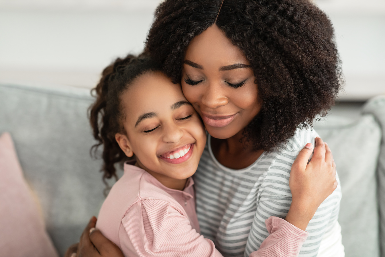 Closeup Portrait of Happy Black Mother and Daughter Hugging